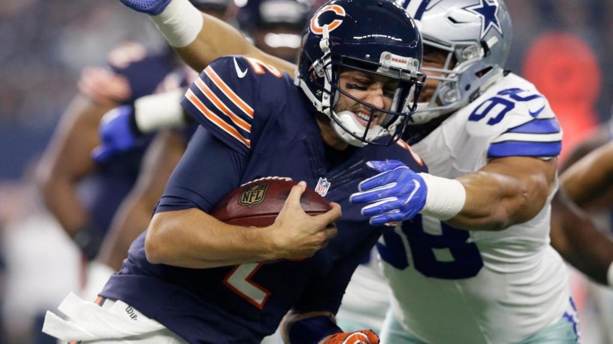 Chicago Bears quarterback Brian Hoyer is tackled by Dallas Cowboys defensive tackle Tyrone Crawford (98) in the first half of an NFL football game, Sunday, Sept. 25, 2016, in Arlington, Texas.
