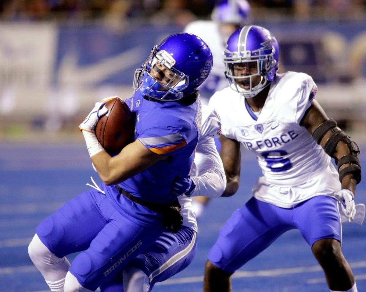 Boise State wide receiver Sean Modster (8) runs the ball against Air Force defensive back Jeremy Fejedelem, obscured, and linebacker Lakota Wills (8) during the first half last last year at Albertsons Stadium in Boise. Boise State won 44-19.