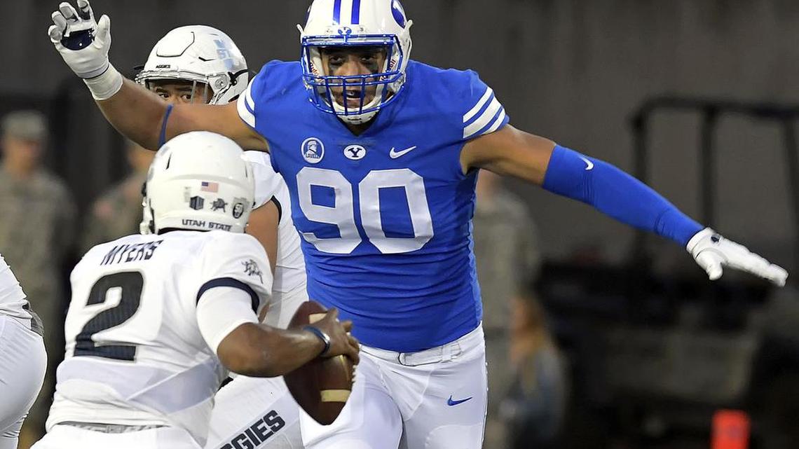 Utah State quarterback Kent Myers scrambles to avoid BYU defensive lineman Corbin Kaufusi last week.