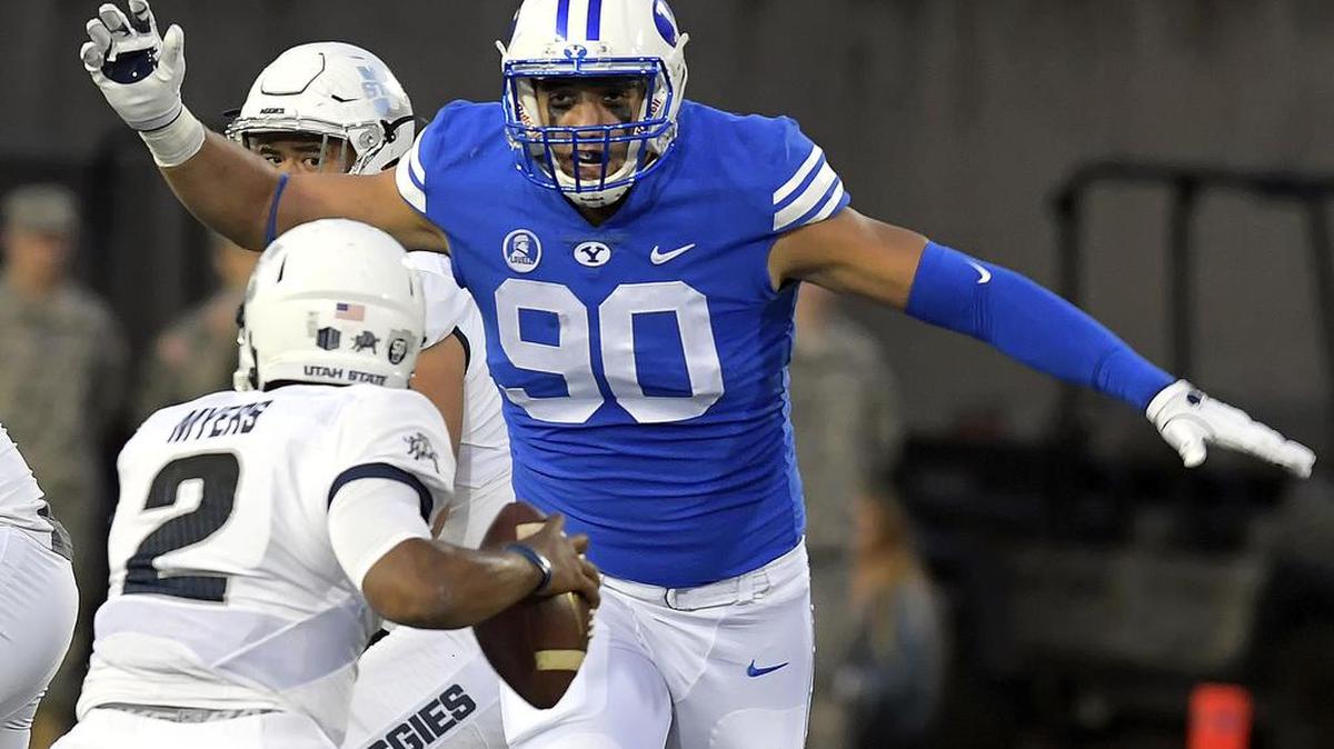 Utah State quarterback Kent Myers scrambles to avoid BYU defensive lineman Corbin Kaufusi last week.
