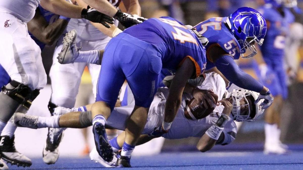 Boise State linebacker Darren Lee (44) and nose tackle David Moa (55) sack Washington State quarterback Luke Falk during the second half Saturday night at Bronco Stadium.
