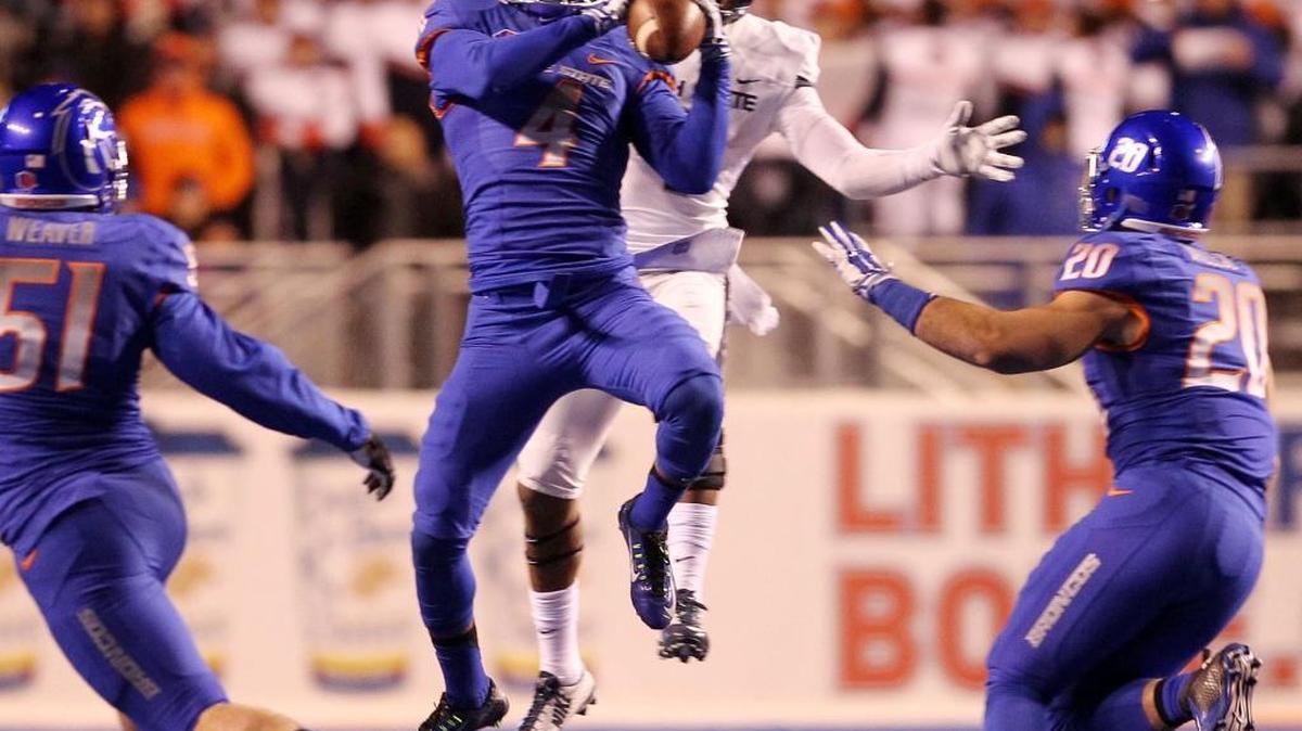 Boise State safety Darian Thompson intercepts a Utah State pass at Albertsons Stadium in 2014.