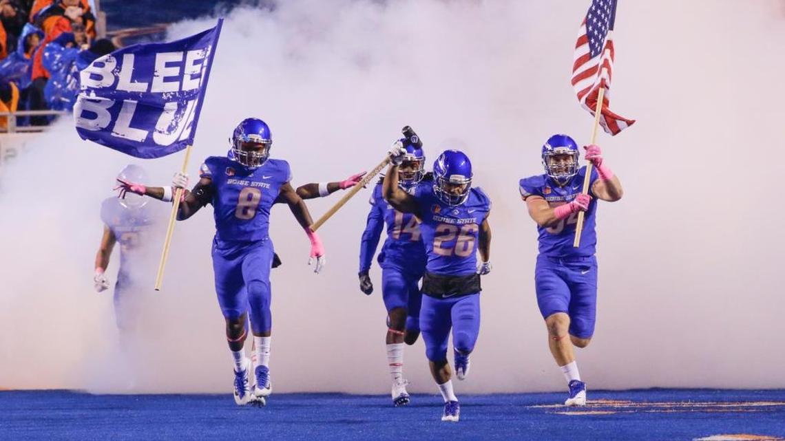 Boise State's Jabril Frazier (8), Avery Williams (26) and Matt Locher (54) lead the team onto the field before Oct. 21’s game against Wyoming at Albertsons Stadium.