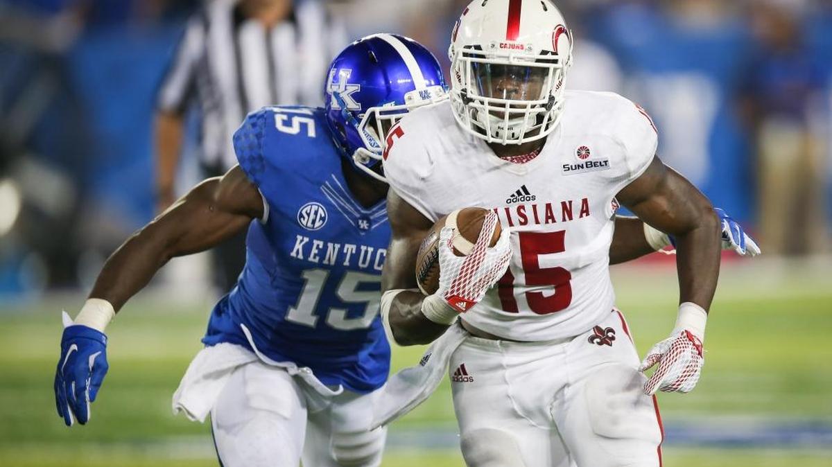 Louisiana-Lafayette running back Elijah McGuire, right, runs the ball while being chased by Kentucky safety Marcus McWilson during the second half of an NCAA college football game in Lexington, Ky., Saturday, Sept. 5, 2015.