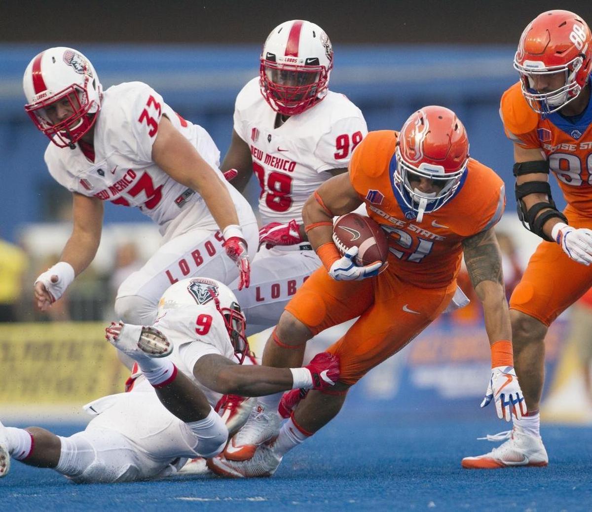 Boise State running back Ryan Wolpin gains yards on the New Mexico defense before being tripped up by defensive back Stanley Barnwell Jr. on Sept. 14 at Albertsons Stadium in Boise.