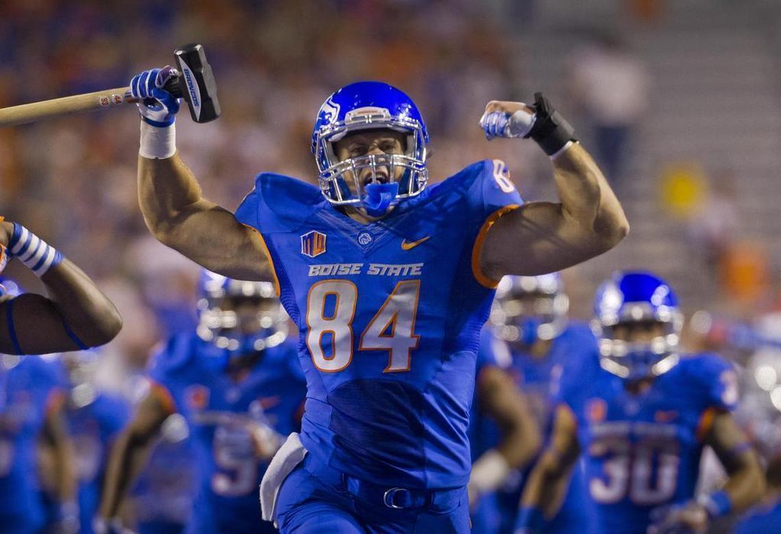 Boise State tight end Jake Knight (84) leads the Broncos onto the blue turf of Albertsons Stadium for the home opener with Washington State Saturday Sept. 10, 2016 in Boise.