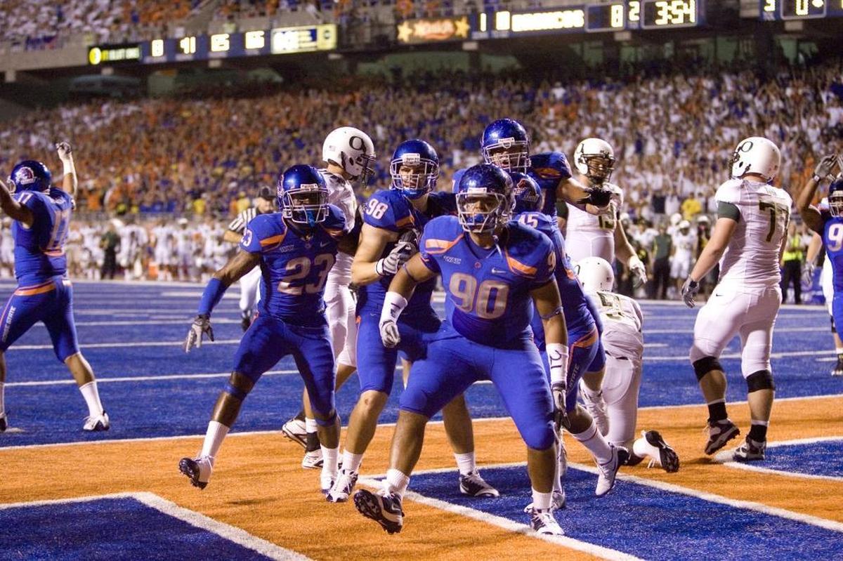 Boise State’s defense, led by Billy Winn (90), celebrates during the 2009 game against Oregon.