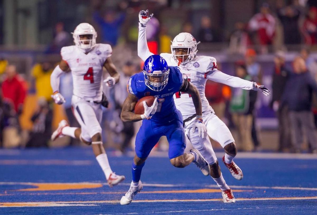 Boise State wide receiver Cedrick Wilson (1) keeps on his feet after a long pass reception while defended by Fresno State defensive back Jaron Bryant (14) in the fourth quarter of the Mountain West championship game Dec. 2 at Albertsons Stadium in Boise.