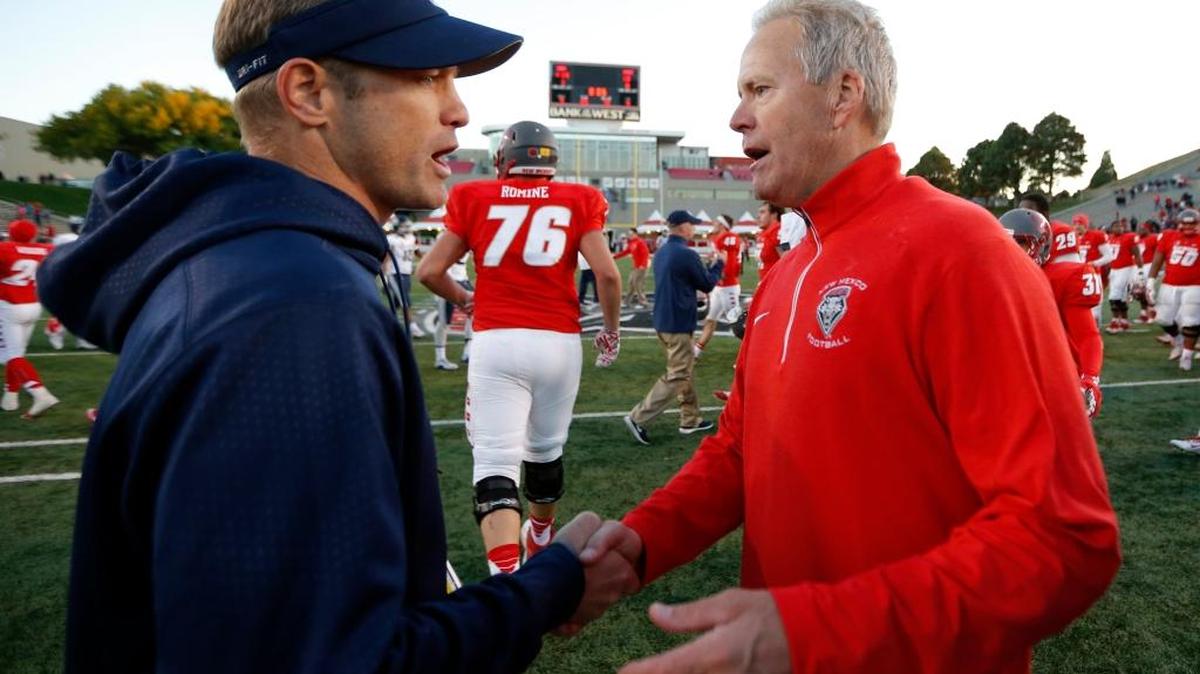 New Mexico football coach Bob Davie, right, is congratulated by Utah State coach Matt Wells at the end of a their Mountain West game in Albuquerque, N.M., on Saturday, Nov. 7, 2015. New Mexico won 14-13.