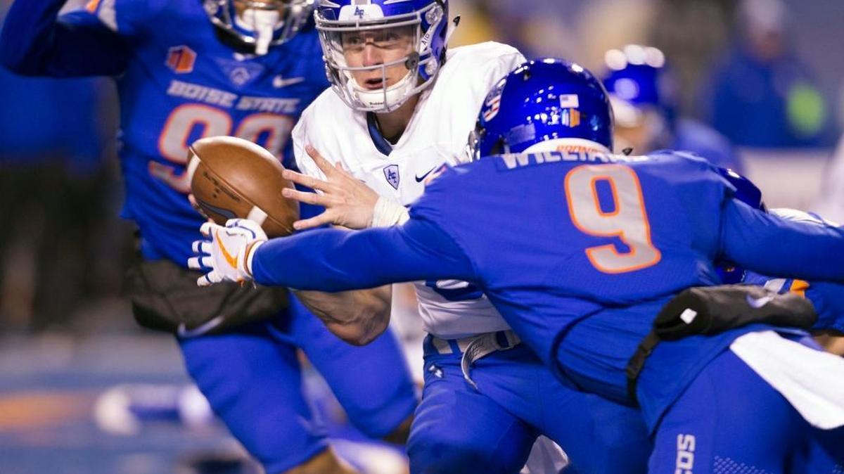 Air Force quarterback Nate Romine (6) laterals the football as he is met by Boise State linebacker Desmond Williams (9) last Saturday at Albertsons Stadium in Boise.
