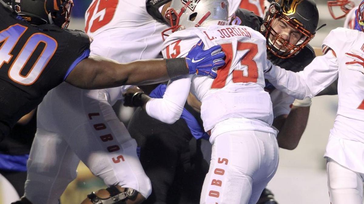 Boise State defensive tackles Tyler Horn (69) and Armand Nance (40) sack New Mexico quarterback Lamar Jordan Saturday Nov. 14, 2015 at Albertsons Stadium in Boise.