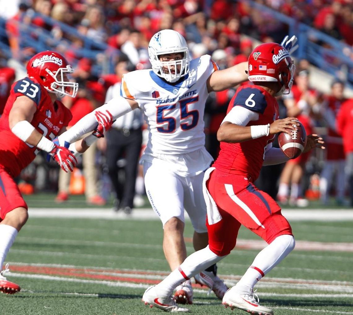 Fresno State quarterback Marcus McMaryion, right, drops back to pass as Boise State defensive tackle David Moa rushes toward him last November.