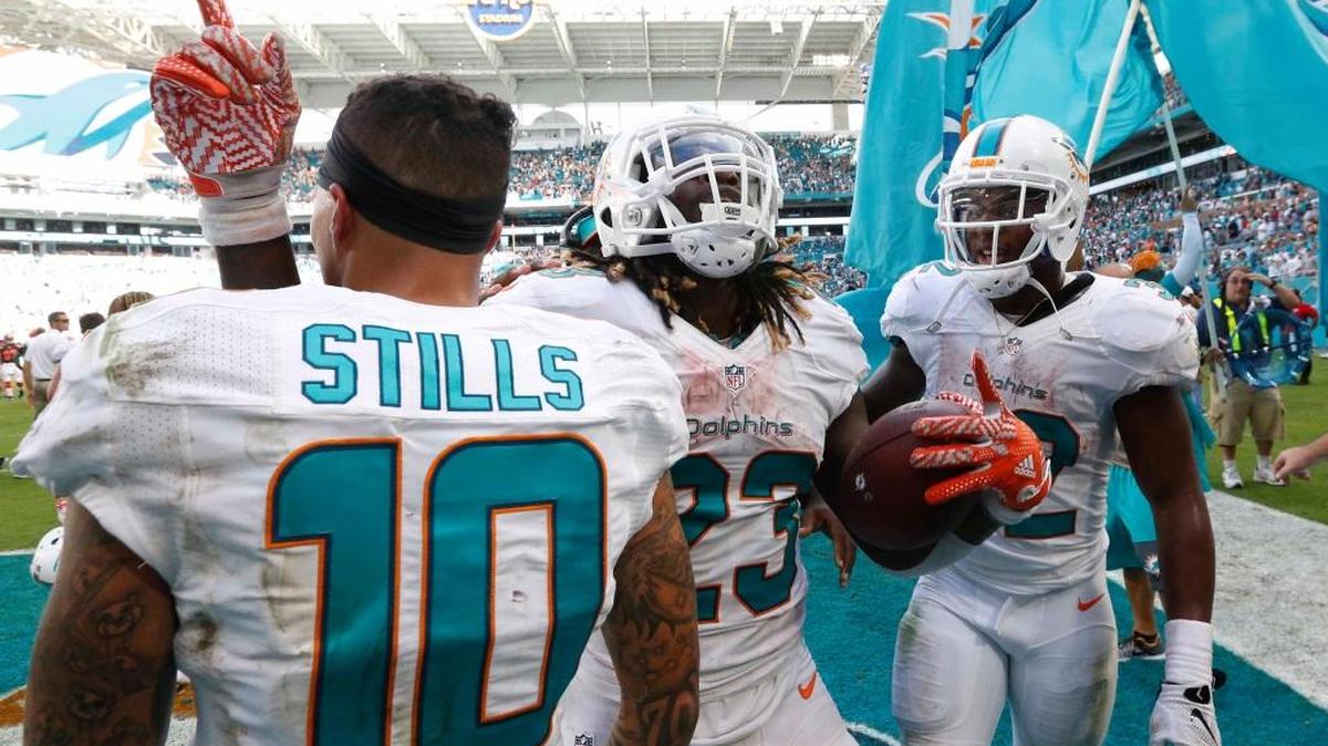 Miami Dolphins running back Jay Ajayi (23) celebrates his game winning touchdown during overtime at an NFL football game against the Cleveland Browns, Sunday, Sept. 25, 2016, in Miami Gardens, Fla.