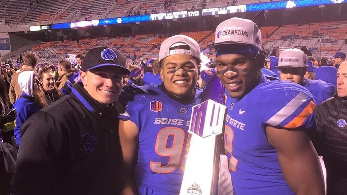 Spencer Danielson, left, poses with Curtis Weaver and Jabril Frazier after winning the Mountain West championship. Danielson was promoted from graduate assistant to a full-time role Friday.