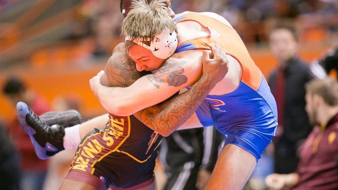 BSU wrestler Austin Dewey (right) competed in the popular Beauty and the Beast joint gymnastics and wrestling event at Taco Bell Arena in 2015.