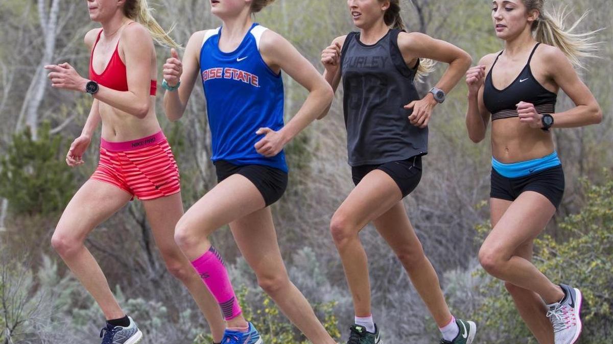Distance runner Allie Ostrander, in her blue BSU gear, trains with teammates on Shaw Mountain Road in Boise.