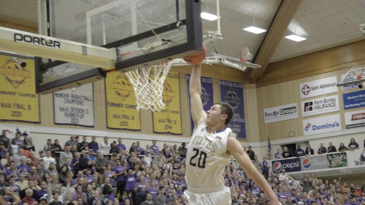 College of Idaho forward Joey Nebeker dunks during a nonconference men’s basketball game against Northwest Nazarene on Tuesday, Nov. 24, 2015, in Caldwell, Idaho. The Yotes beat the Crusaders 75-71.