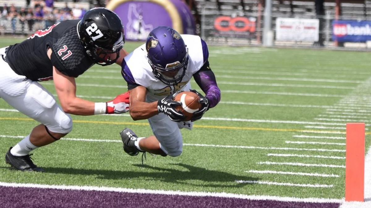 College of Idaho running back Mike Kirby, right, dives past Montana Western defensive back Jay Owens into the end zone for a touchdown in an NAIA football game Saturday, Sept. 3, 2016, at Simplot Stadium in Caldwell.