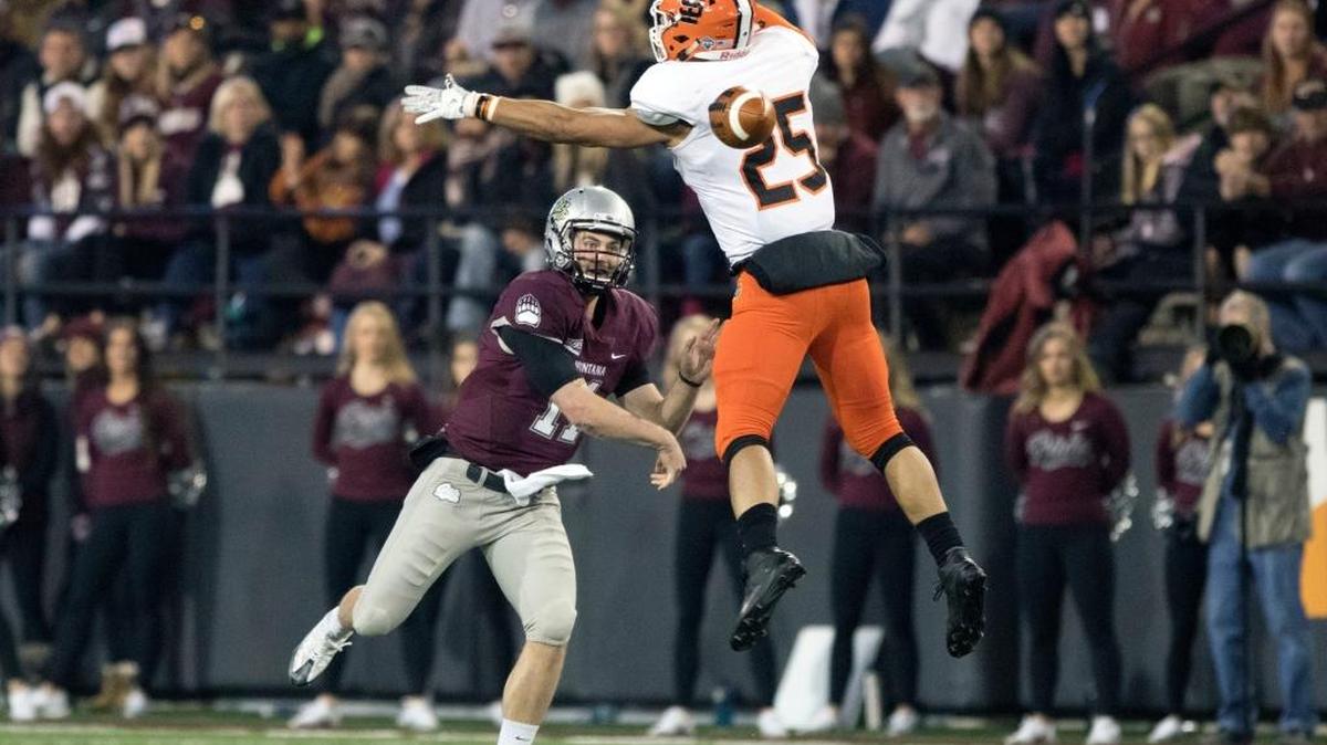 Montana quarterback Chad Chalich (11) throws a pass under pressure from Idaho State linebacker Joe Martin (25) in the first half of an NCAA college football game Saturday, Nov. 5, 2016, in Missoula, Mont.