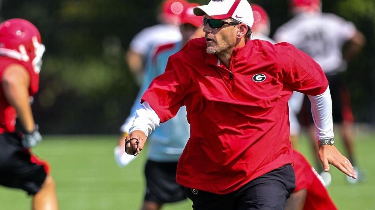 In this Aug. 2, 2012 file photo, Georgia Bulldogs offensive coordinator Mike Bobo runs a practice drill in Athens, Ga. Bobo, now the Colorado State head coach, and Idaho’s Paul Petrino were SEC coordinators before taking head coaching jobs that have led them to the 2016 Famous Idaho Potato Bowl, which will be played Dec. 22 at Albertsons Stadium in Boise.