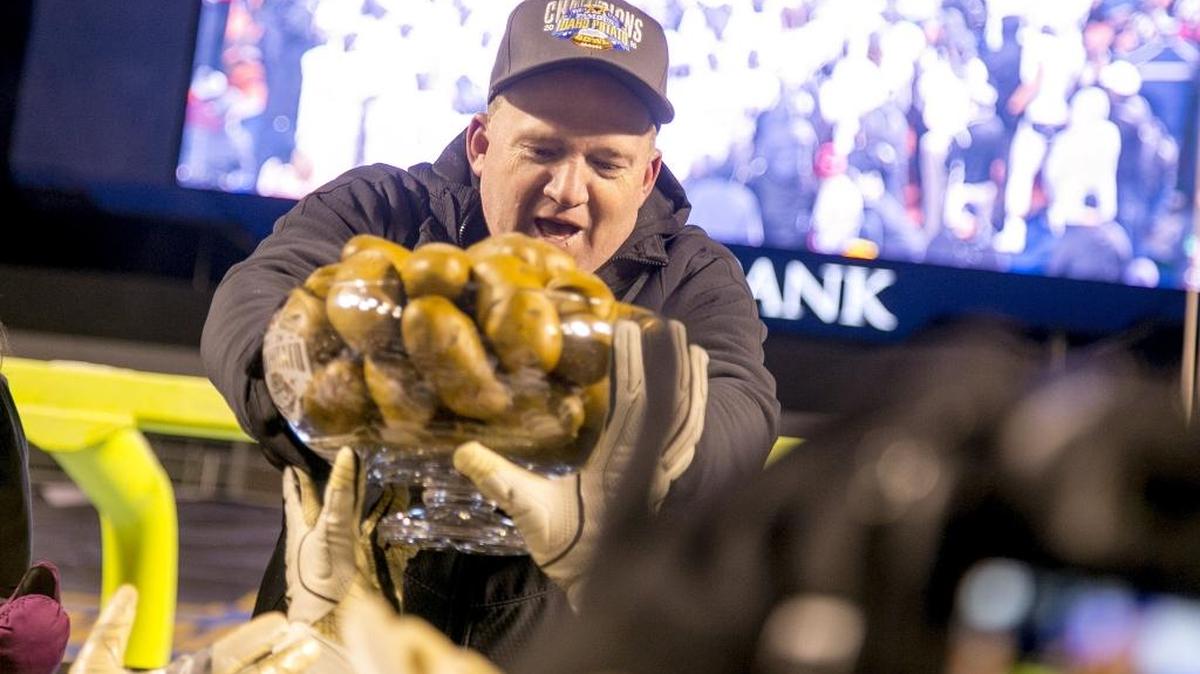 University of Idaho head coach Paul Petrino hands his players a trophy filled with potatoes after the Famous Idaho Potato Bowl on Thursday, Dec. 22, 2016, at Albertsons Stadium in Boise. Idaho beat Colorado State 61-50.