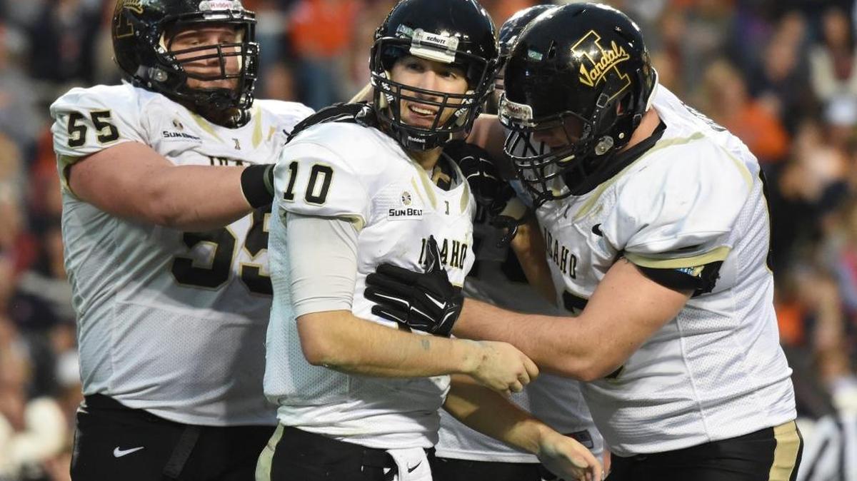 Idaho quarterback Matt Linehan (10) is congratulated by Dallas Sandberg (55) and Calvin White after running for a touchdown against Auburn during the first half of an NCAA football game, Saturday, Nov. 21, 2015, in Auburn, Ala.