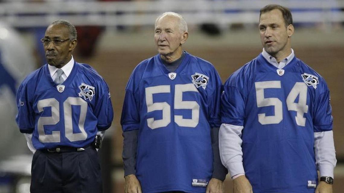 In this Nov. 9, 2008, file photo, Former Detroit Lions players Lem Barney (20), Wayne Walker (55) and Chris Spielman (54) stand during a halftime ceremony in Detroit, naming the team's 75th season all-time team. Walker, a Pro Bowl linebacker for the Lions and a broadcaster, has died. He was 80. The Lions say Walker died Friday in Boise. Walker said in 2015 he had Parkinson’s disease.