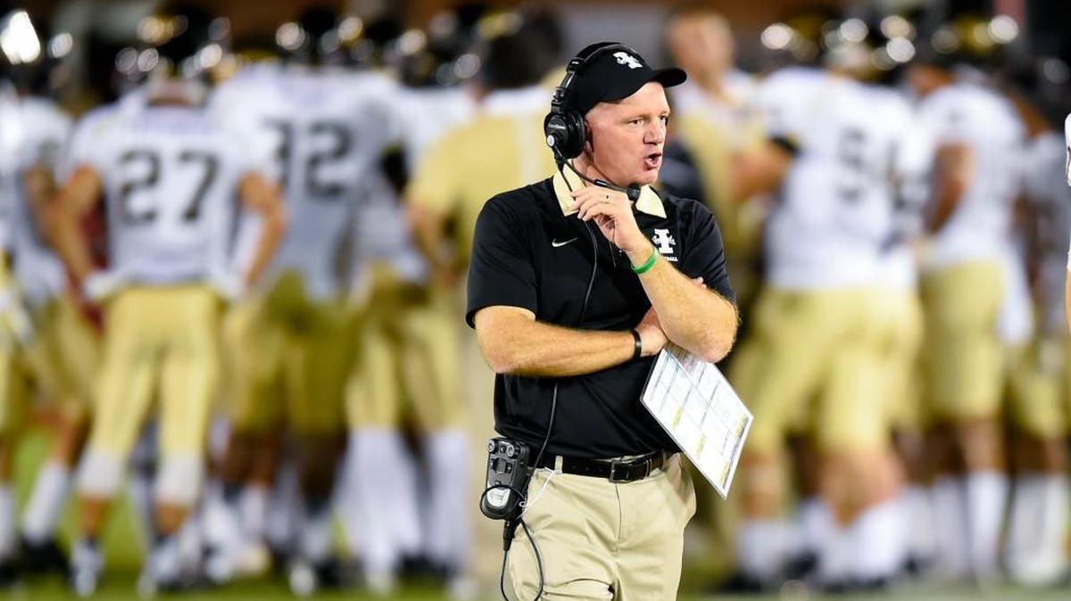 Idaho coach Paul Petrino talks to players from the sideline during a game last season.