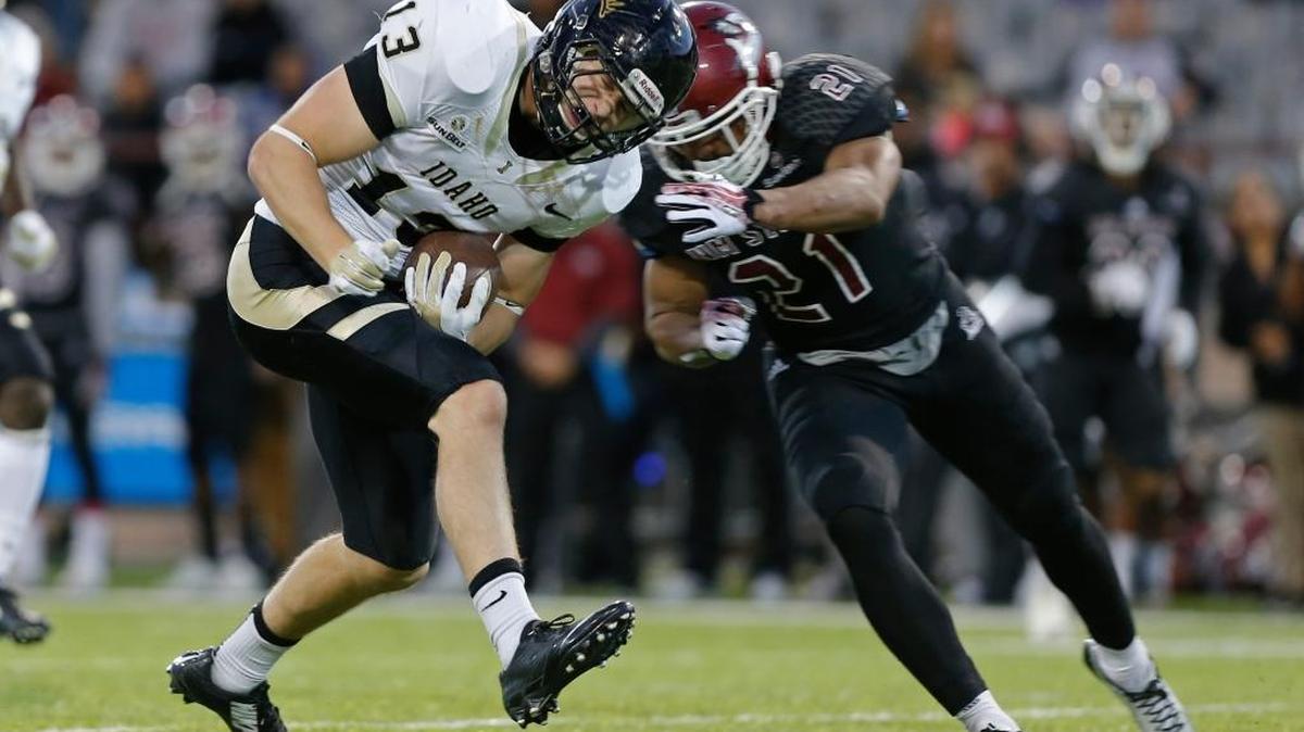 Idaho tight end Buck Cowan is tackled by New Mexico State defensive back Jaden Wright during the first half of Saturday’s Sun Belt football game in Las Cruces, N.M. New Mexico State won 55-48 in overtime.