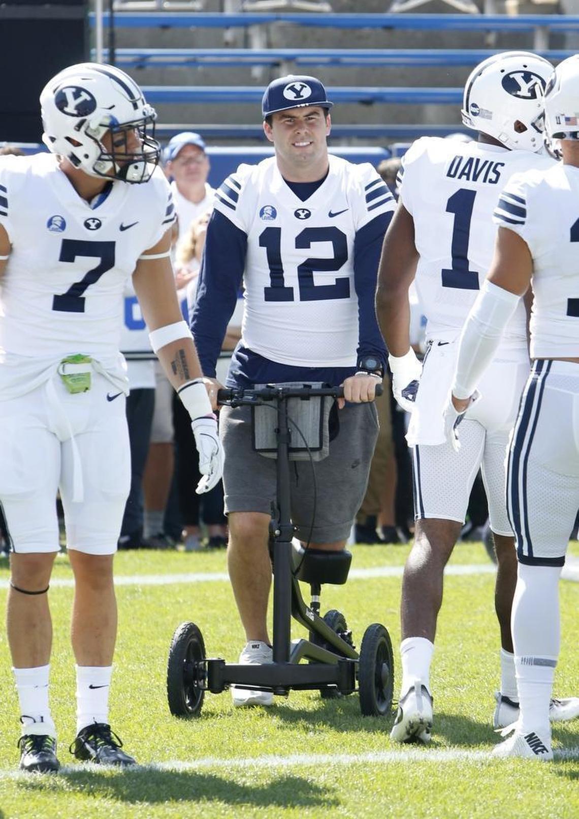 BYU starting quarterback Tanner Mangum watches from the sideline while recovering from an injury as teammate Beau Hoge, left, warms up in his place against Wisconsin on Sept. 16. Mangum is not likely to play this week at Utah State.