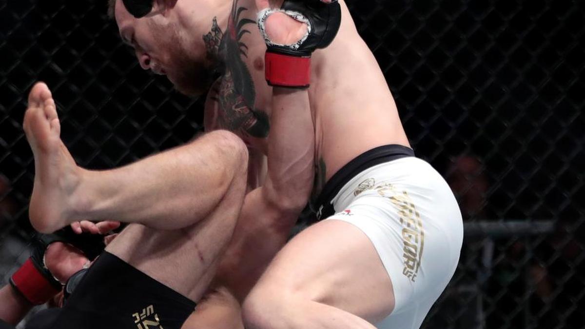 Conor McGregor, right, fights Eddie Alvarez during a lightweight title mixed martial arts bout at UFC 205, early Sunday, Nov. 13, 2016, at Madison Square Garden in New York.