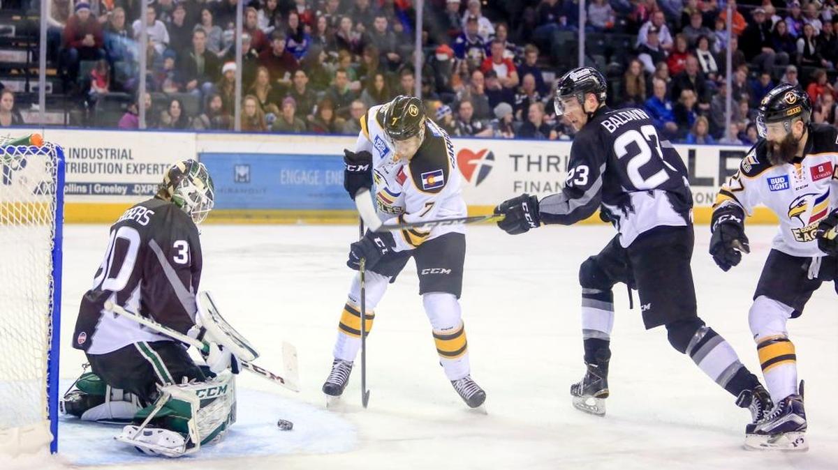 Goalie Philippe Desrosiers stops a shot as defender Corbin Baldwin looks on.