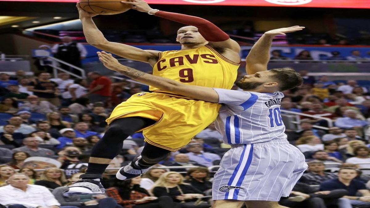 Cleveland Cavaliers guard Jared Cunningham (9) goes up for a shot against Orlando Magic forward Evan Fournier during the first half of an NBA game Dec. 11, 2015, in Orlando, Fla.
