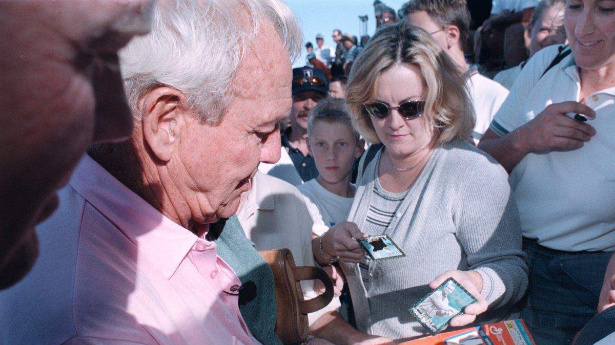 Golfing legend Arnold Palmer signs a Wheaties cereal box as he is surrounded by fans after the Coors Light Skins for College Golf game at Boise's Hillcrest Country Club in 2000. Palmer played along with Buy.com Tour player Mark Hensby and PGA Tour professionals John Cook and Notah Begay III.