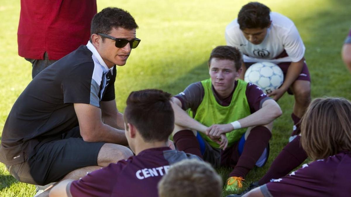Former MLS player Logan Emory talks to his Centennial boys soccer team last fall during a break against Timberline.