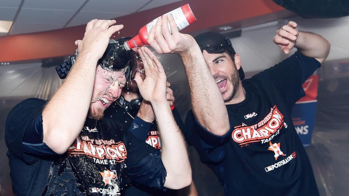Boise High grad James Hoyt, right, pours beer on teammate Chris Devenski after the Astros clinched the AL West title in September.