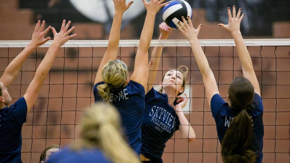 Skyview High volleyball player Olivia Bradley, center, hits a ball during practice.