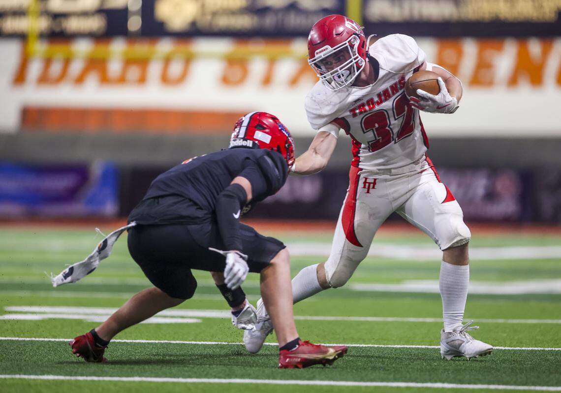 Homedale senior Javid Blewett tries to avoid a tackle by Kimberly junior Joe Barrett in the 4A state championship game Saturday. 