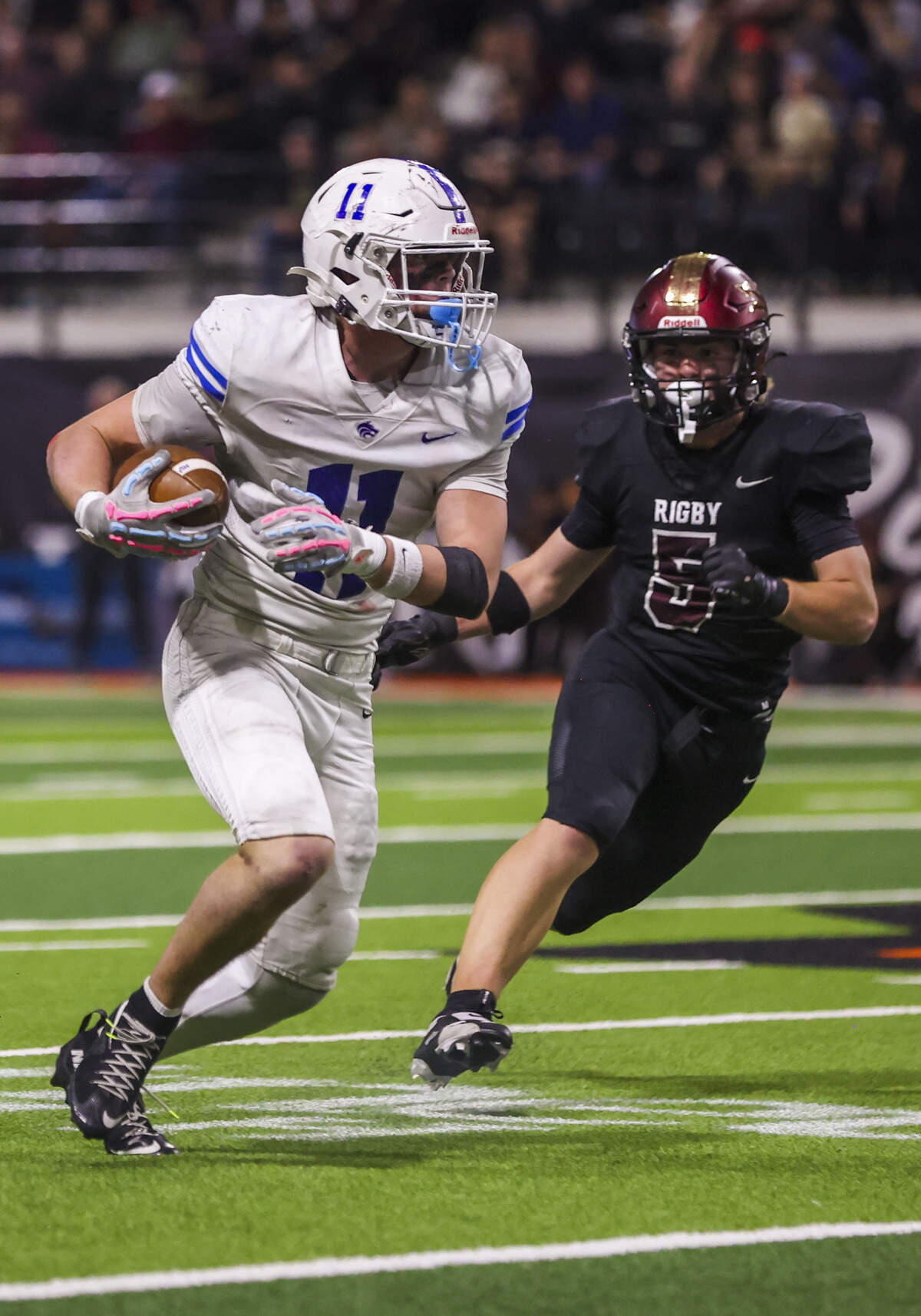 Timberline senior Nash O'Kelley runs away from Rigby senior DJ Bouderero and into the open field Saturday in the 6A state championship game.