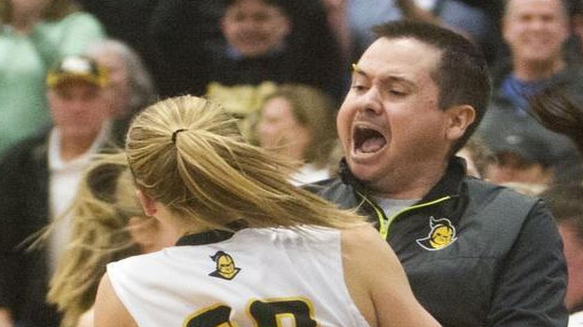 Bishop Kelly girls basketball coach Derek McCormick celebrates with his team after its 52-50 win over Minico in the 4A state semifinals Feb. 19 at Timberline High.