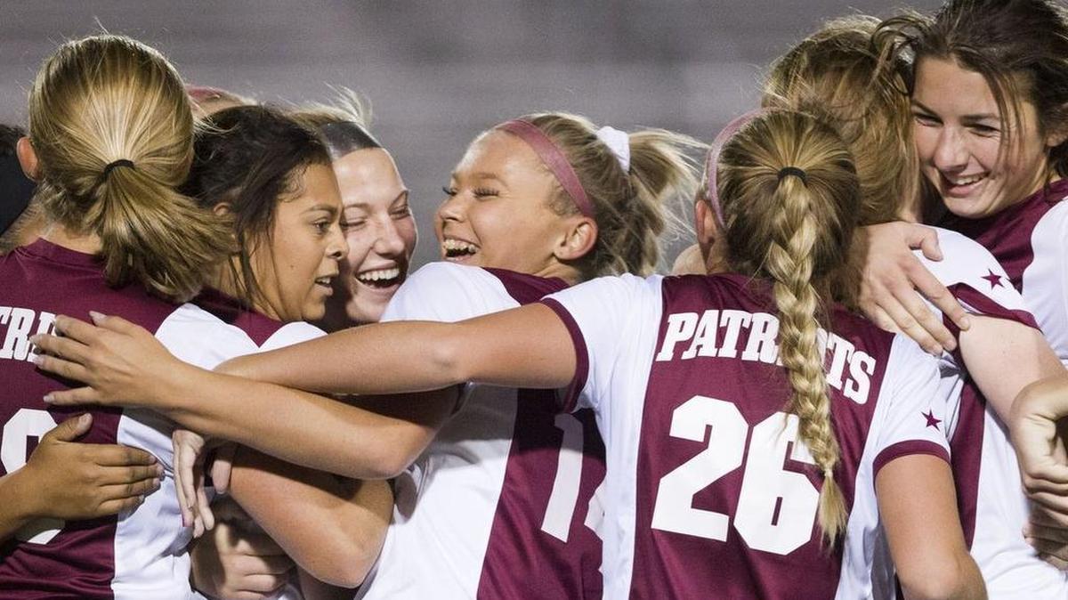 The Centennial girls soccer team celebrates after winning back-to-back 5A district titles last fall.