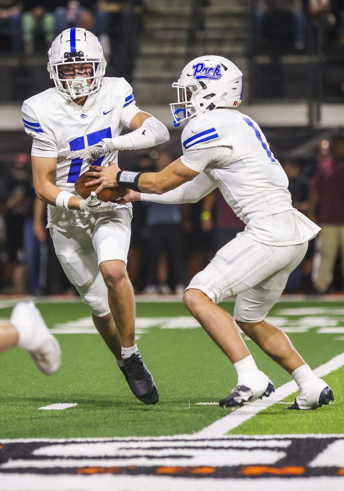 Timberline senior Hudson Lewis hands the ball off to junior Fletch Scudder in the 6A state championship game Saturday. 
