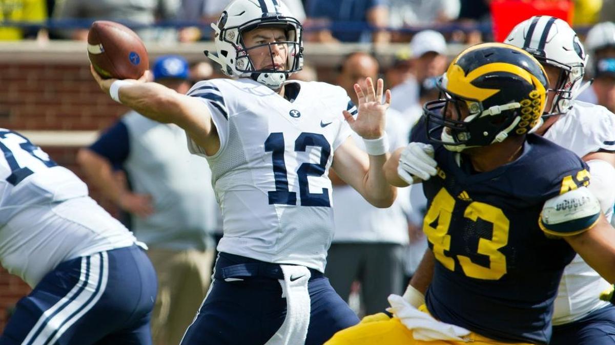 BYU quarterback Tanner Mangum throws from the pocket last season during a 31-0 loss at Michigan. After starting 12 games last season, the former Eagle and Timberline quarterback is fighting for the starting job in 2016.