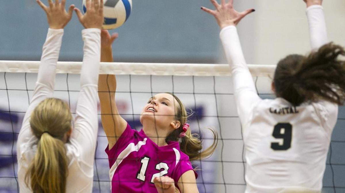 Timberline’s Natalia DeMordaunt (middle) slams down a shot against Capital on Sept. 29. The Wolves enter the 5A state tournament at Post Falls High as the District Three champion.