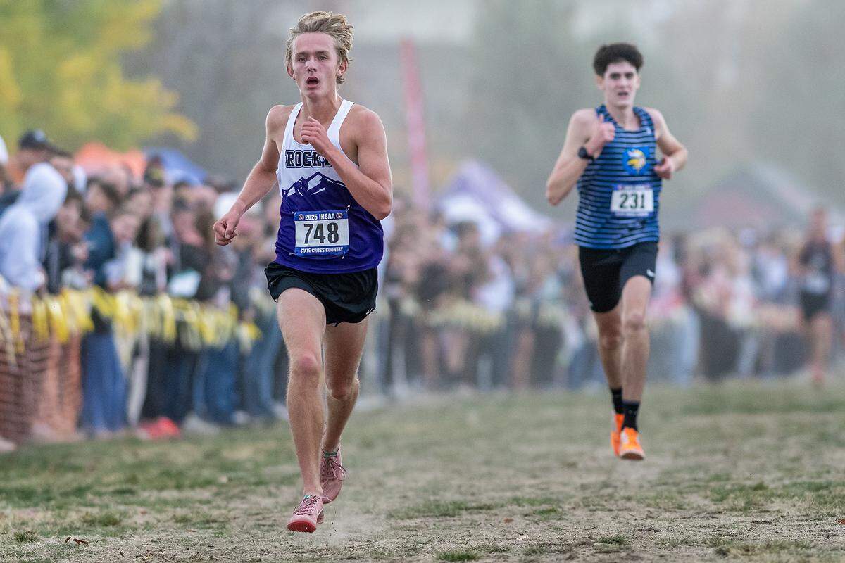 Rocky Mountain’s Hyrum Tuft charges down the finish line to win the 6A boys race at the Idaho state cross country meet last fall in the Lewiston Orchards.