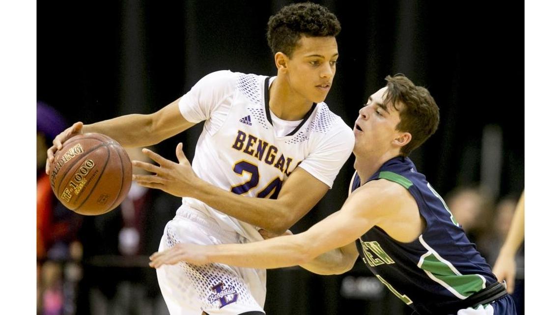 Mountain View’s Spencer Erickson, right, defends Lewiston’s Riley Way during the first round of the 2017 5A boys basketball state tournament at the Ford Idaho Center in Nampa.