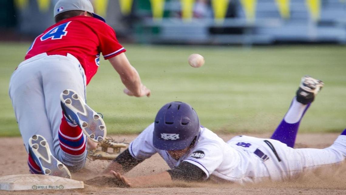 Rocky Mountain’s Payton Lewis slides into second base before Coeur d’Alene’s Cody Davenport can corral the throw Thursday during the first round of the 5A state tournament at Borah High.