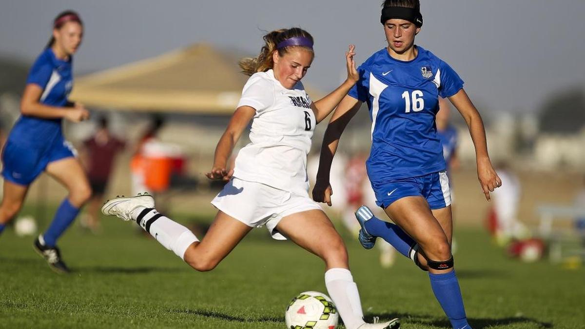 Rocky Mountain’s Raimee Sherle winds up for a shot in the 5A district semifinals in front of Timberline’s Brooke Felzien.