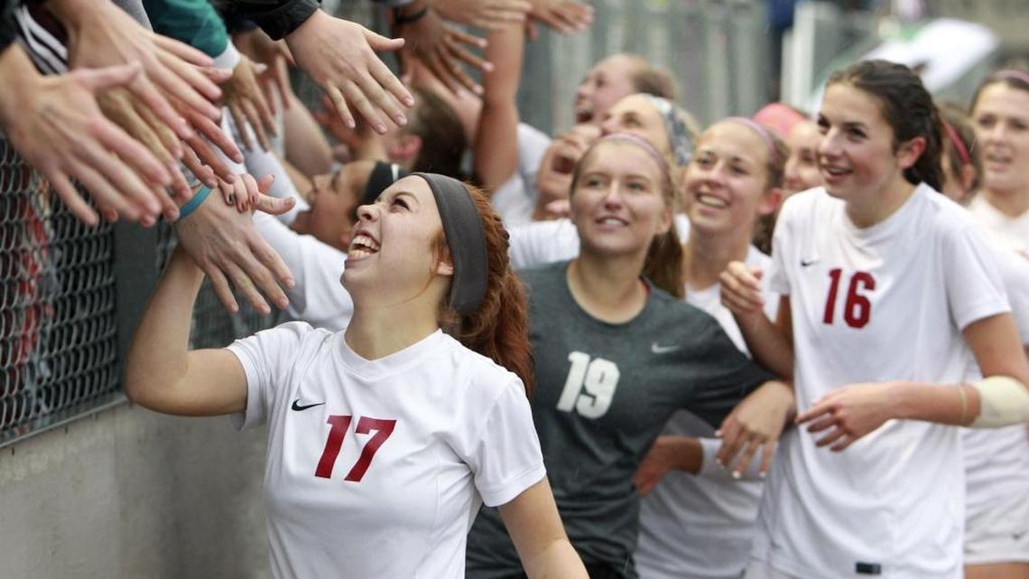 Centennial’s Cheyenne Rede (17) celebrates with Patriots fans after Centennial beat Mountain 4-0 for the 5A state championship Saturday at Rocky Mountain High.