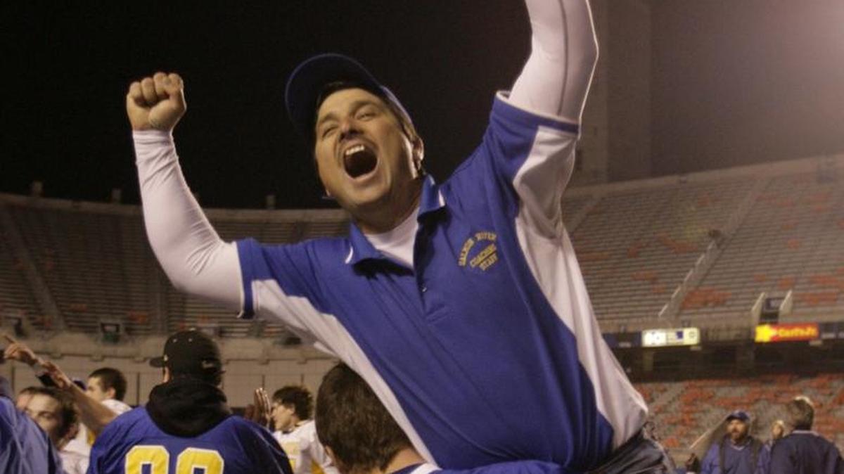 Salmon River’s Kyle Brady hoists then-assistant coach Charlie Shepherd after the Savages won the 2007 1A Division II football title at Bronco Stadium.